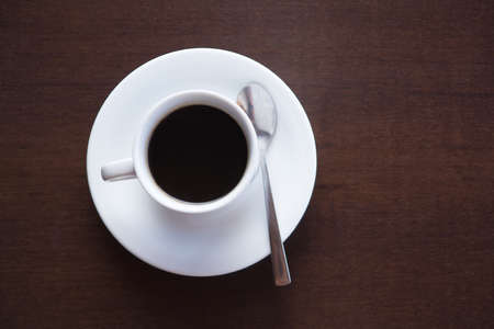 cup of black coffee on wooden tableの写真素材