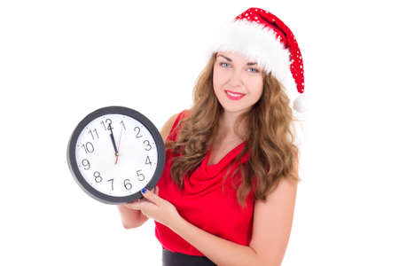 woman in santa hat with clock isolated on white backgroundの写真素材