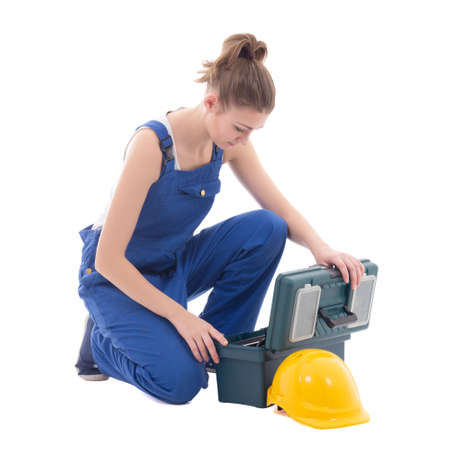 young attractive woman builder in blue workwear with toolbox isolated on white backgroundの写真素材