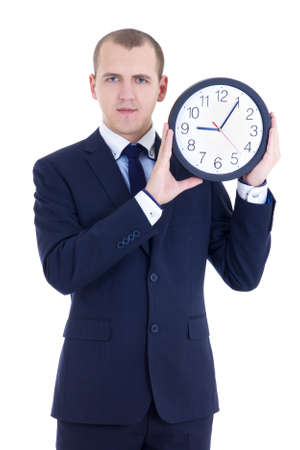 young man in business suit holding office clock isolated on white backgroundの写真素材