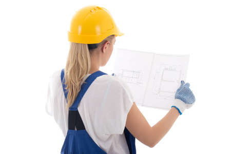 back view of woman in blue builder uniform holding building project isolated on white background