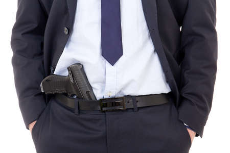 detective, policeman or bodyguard with gun in pants isolated on white background