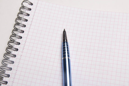 close up of pen on blank note book with checked pages
