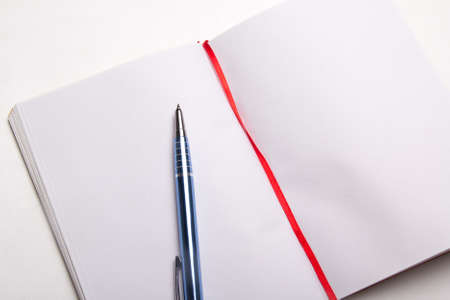 close up of blue pen on blank note bookの写真素材