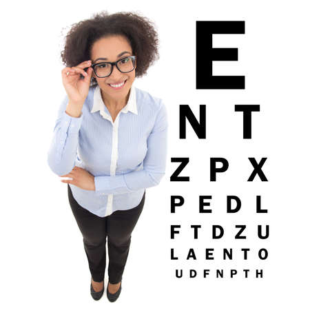 beautiful african american woman in eyeglasses and eye test chart isolated on white backgroundの写真素材