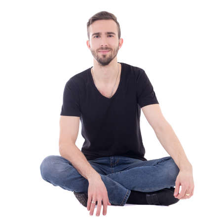 happy young man sitting on the floor isolated on white backgroundの写真素材