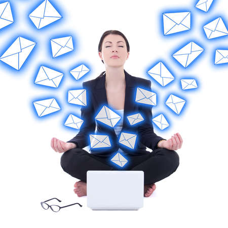 spam concept - young businesswoman sitting in yoga pose with laptop isolated on white backgroundの写真素材