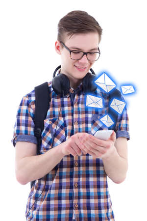 portrait of handsome teenage boy sending messages with smart phone isolated on white background