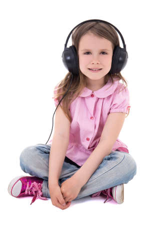 cute little girl listening music in headphones isolated on white backgroundの写真素材