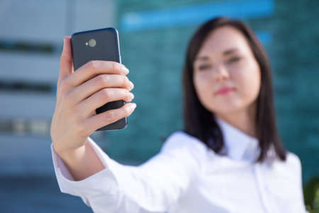 modern smartphone in beautiful business woman's handの写真素材