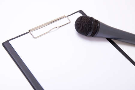 speech or interview concept - microphone and clipboard with blank sheet of paperの写真素材