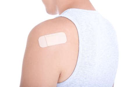 medical adhesive patch on male shoulder isolated on white background