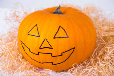 Halloween preparation concept - close up of funny pumpkin with faceの写真素材