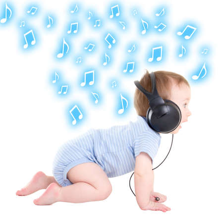 side view of baby boy toddler listening music with headphones over white backgroundの写真素材