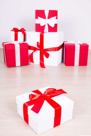 Christmas concept - close up of red and white wrapped gift boxesの写真素材