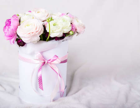 beautiful bunch of summer flowers in round box over white backgroundの写真素材