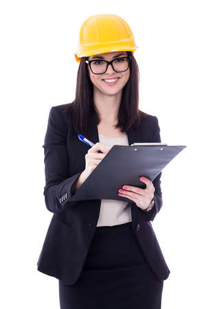 portrait of happy business woman architect in yellow helmet with clipboard isolated on white backgroundの写真素材