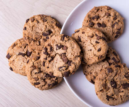 top view of chocolate chip cookies on wooden table background