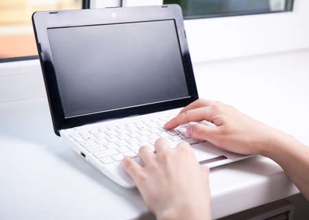 woman using laptop with blank black screen