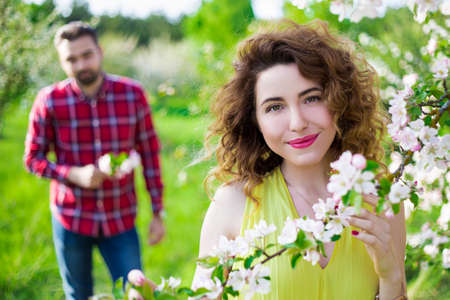 portrait of young beautiful woman with her boyfriend in summer garden
