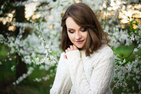 beautiful woman dreaming in blooming summer gardenの写真素材