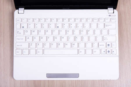 top view of white laptop keyboard on wooden tableの写真素材