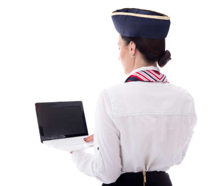 back view of young stewardess showing laptop with blank screen isolated on white backgroundの写真素材