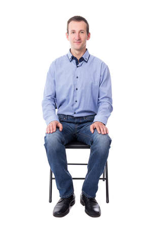 young man sitting on office chair isolated on white backgroundの写真素材