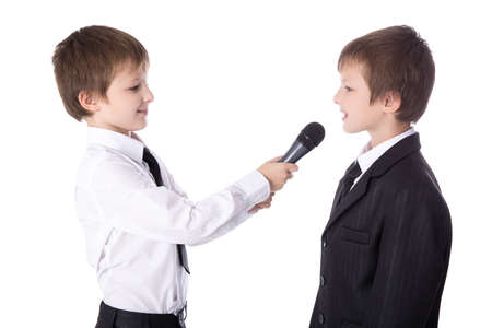 cute little boy reporter with microphone taking interview isolated on white backgroundの写真素材