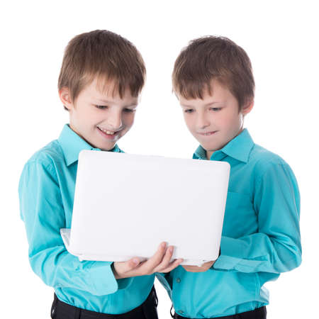 two little boys twins using laptop isolated on white background