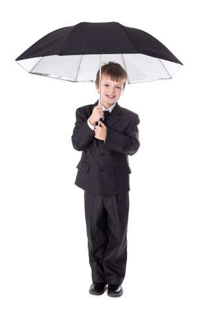 cute little boy in business suit with umbrella isolated on white backgroundの写真素材