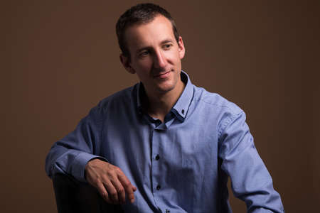 portrait of handsome middle aged man over brown backgroundの写真素材