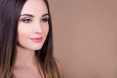natural beauty concept - portrait of young beautiful woman over beige background