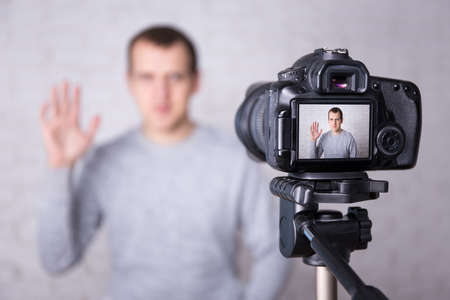 happy video blogger on screen of modern camera