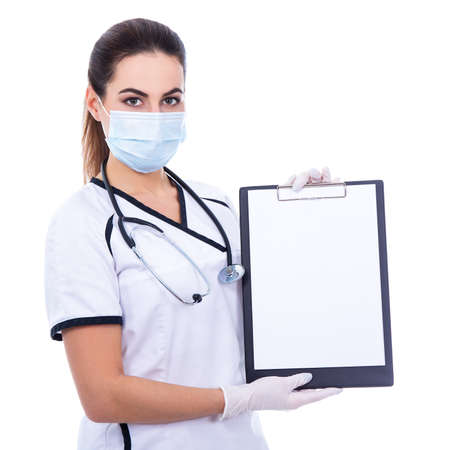 woman doctor in mask holding clipboard with blank paper isolated on white backgroundの写真素材