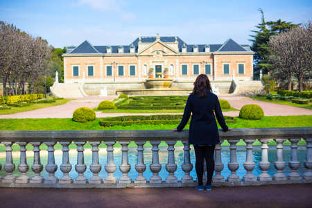 back view of woman walking in summer parkの写真素材