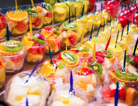 close up of cups with fresh fruit salad in marketの写真素材