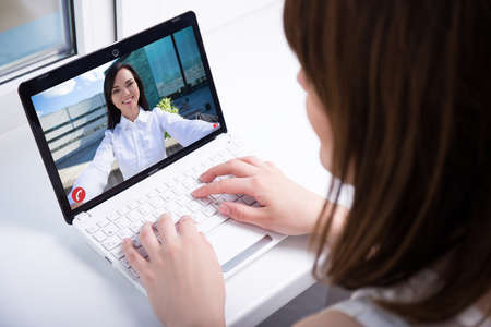 two young women chatting over a video callの写真素材