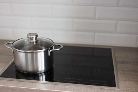 metal pot on electric stove in modern kitchenの写真素材