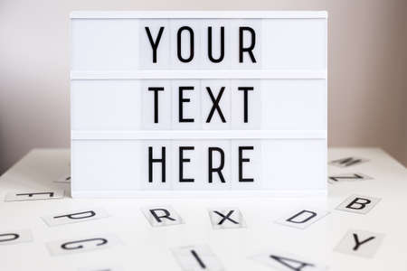 vintage lightbox with words "your text here" and letters on the tableの写真素材