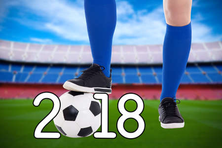 football 2018 concept - soccer player with ball on the stadium
