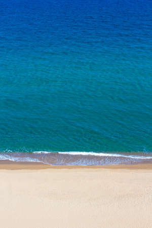 summer background - aerial view of blue sea and yellow sandの写真素材
