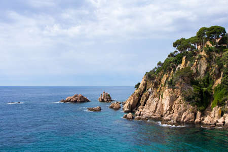 rocky cliff and transparent sea water in Spain