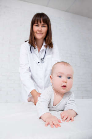 cute little baby with young female doctor pediatrician