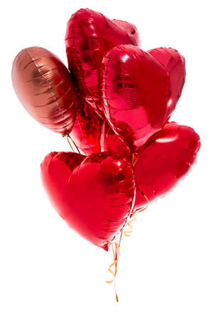 Valentine's day concept - bunch of red heart shaped foil balloons isolated on white backgroundの写真素材