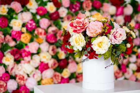 close up of summer bouquet of flowers in vase on the table over colorful background with copy spaceの写真素材