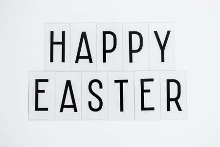 Close up of happy Easter greetings over white background