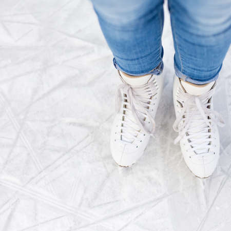 top view of legs in skates over scratched iceの写真素材