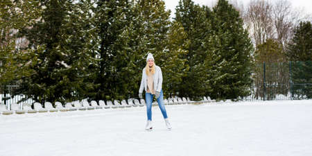 happy young woman on outdoor skating rink