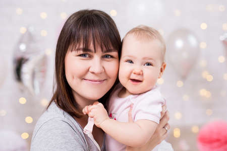 close up portrait of cute little baby girl and her motherの写真素材
